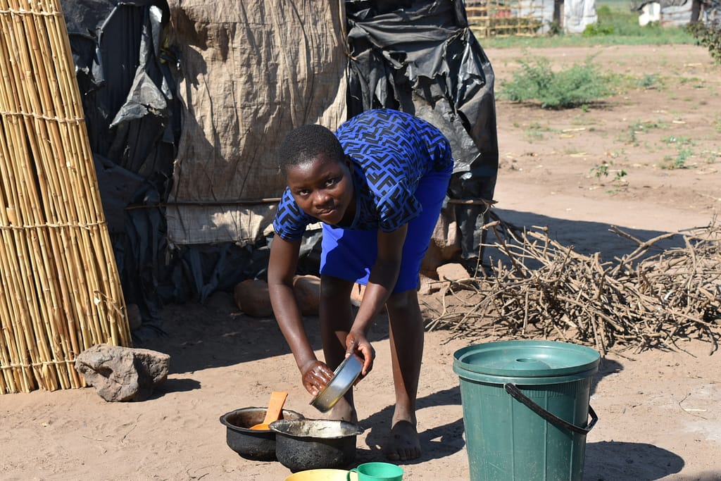Chrissy washes dishes